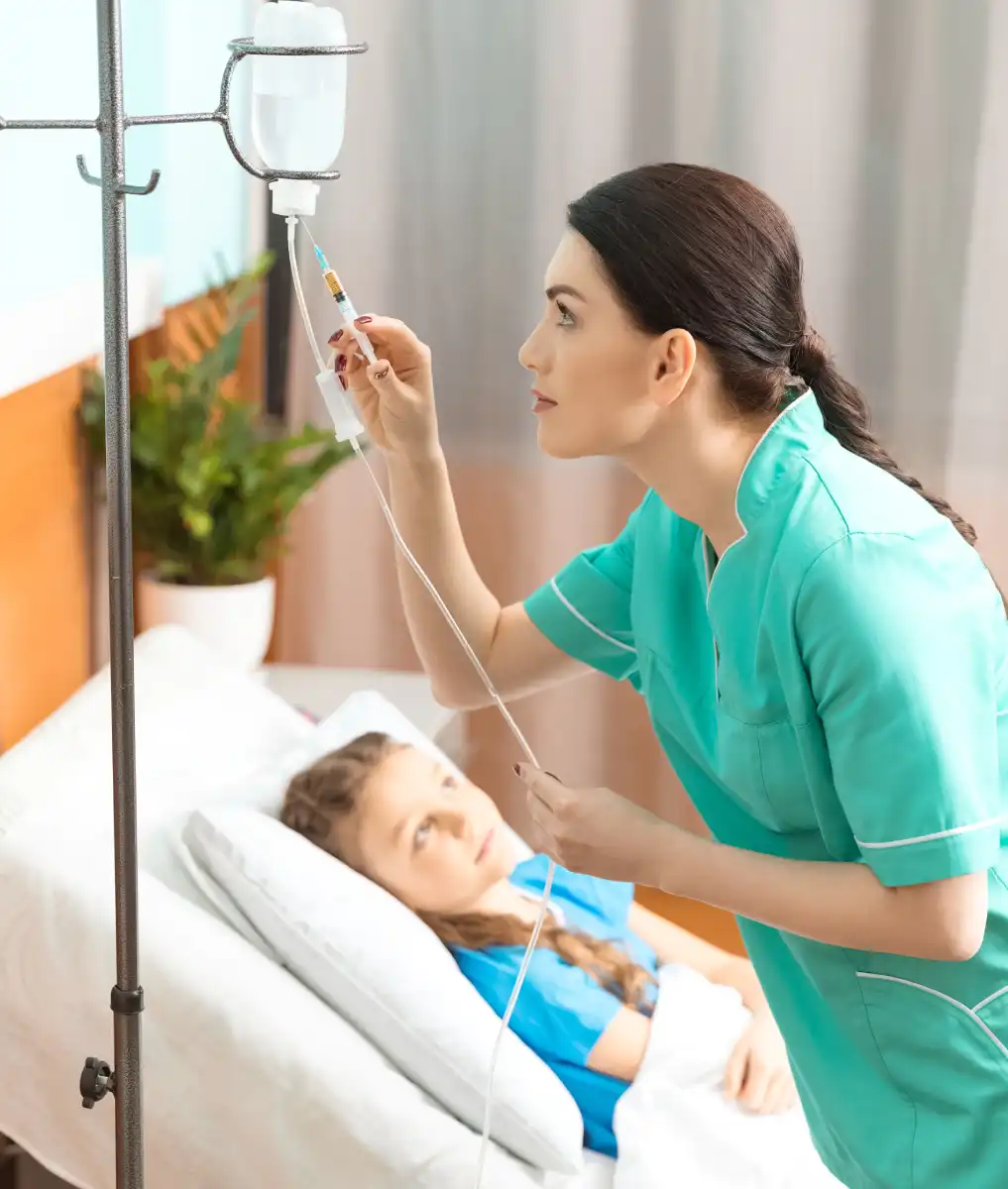 nurse caring for child with medical equipment